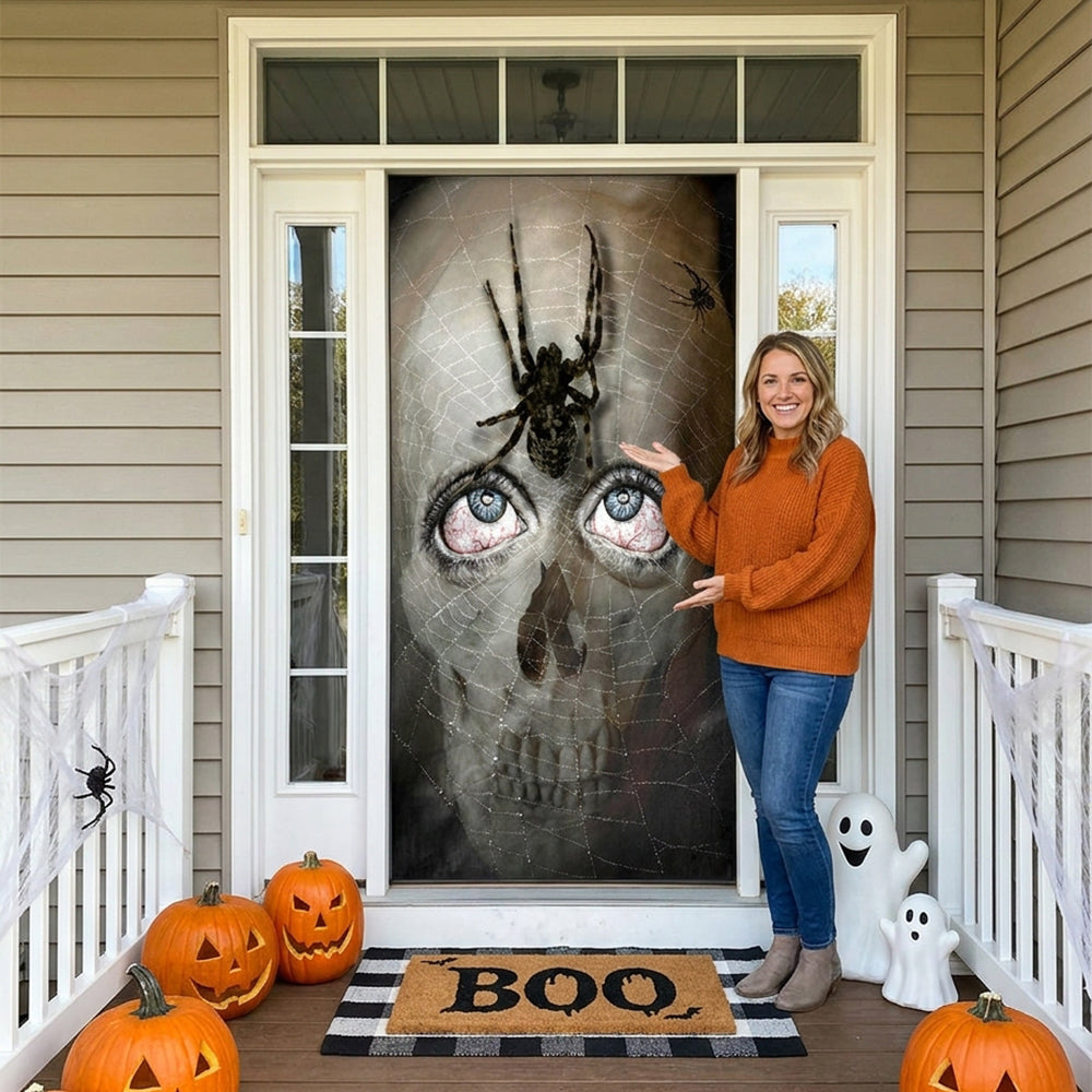 Woman standing in front of a Halloween-themed door cover with pumpkins and a ghost decoration on a porch.